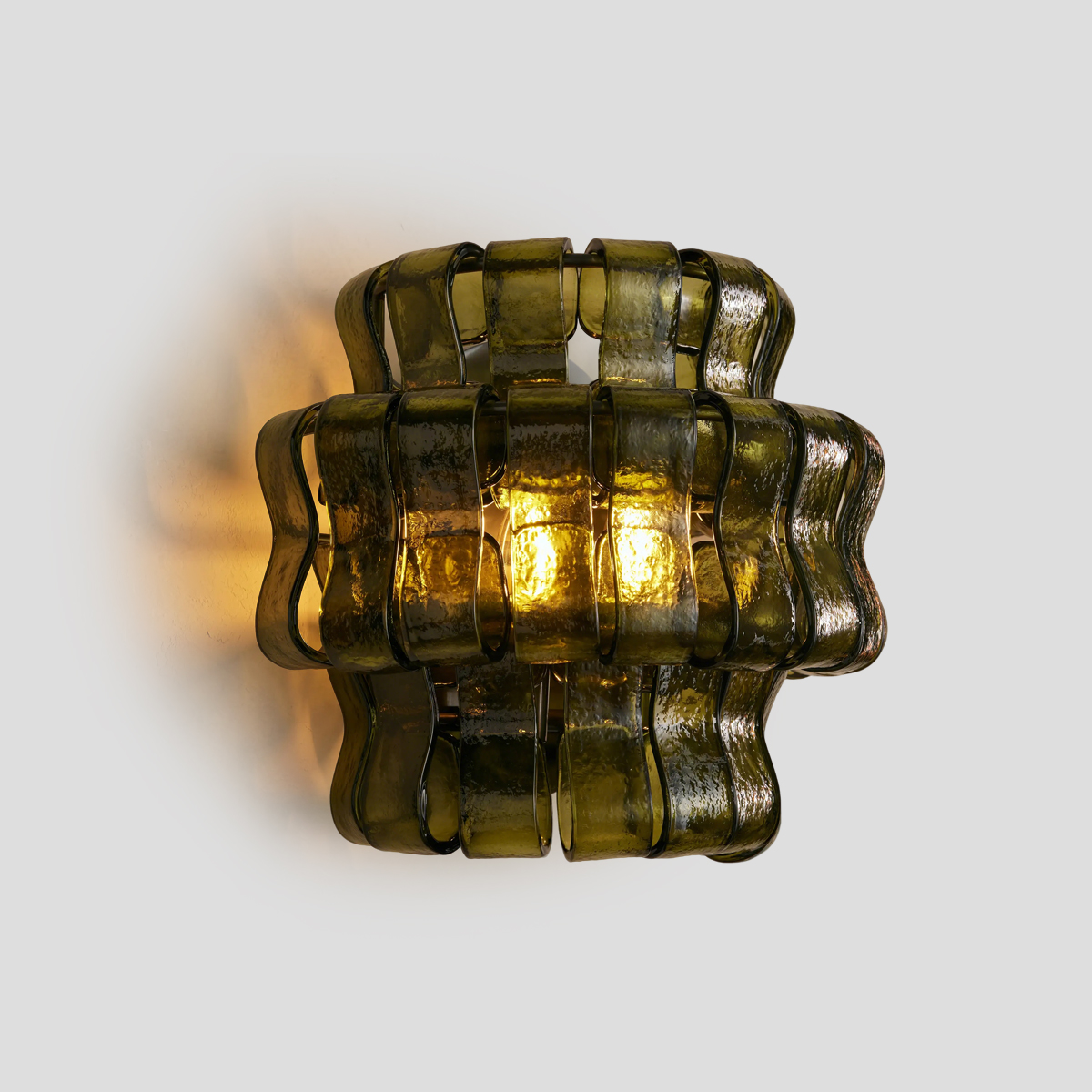 Vintage Green Glass Sconce 1 Elevate your home with this vintage green glass sconce. Featuring tiered, wavy olive glass and a warm amber glow, perfect for mid-century modern spaces. Shop now!