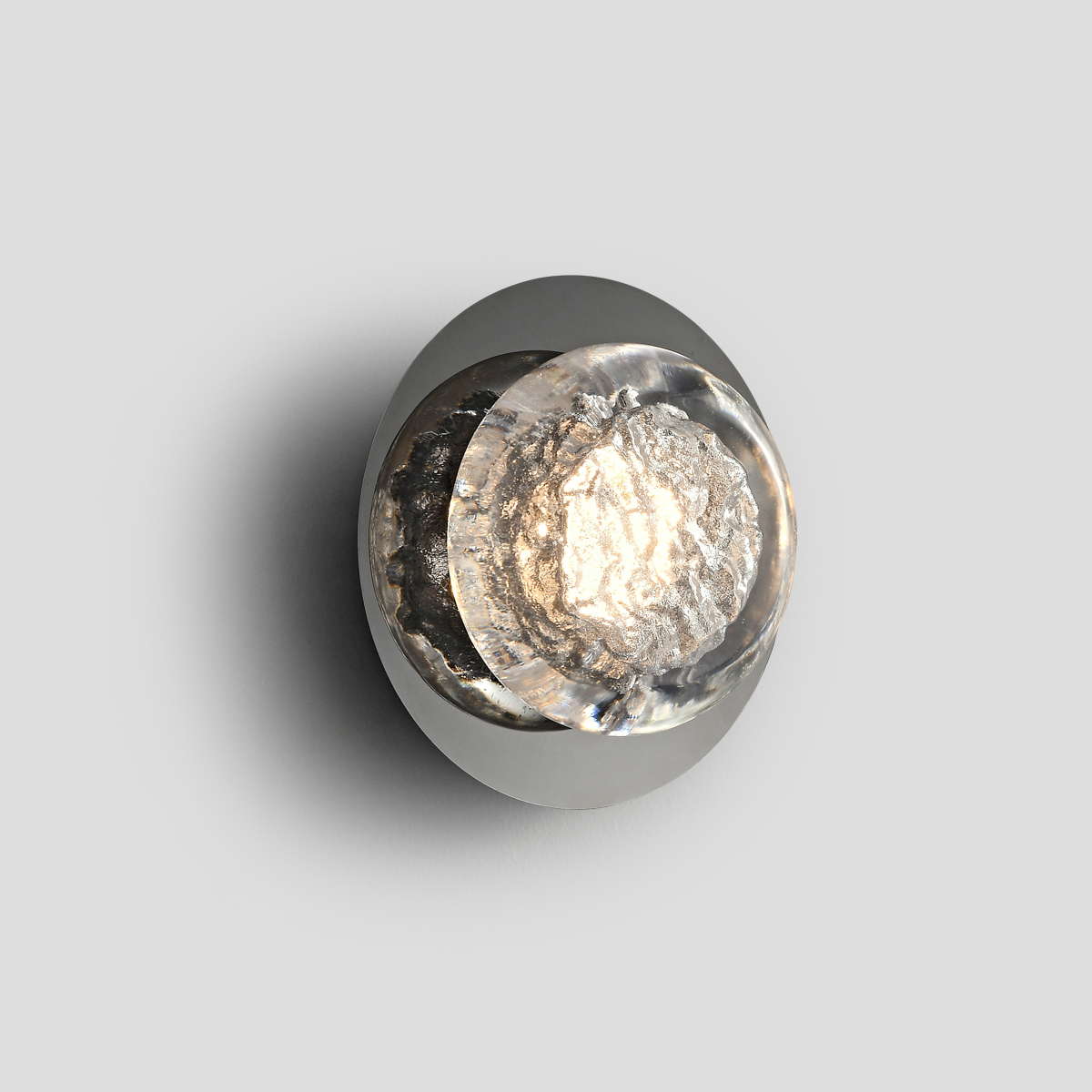 Modern Ice Glass LED Wall Sconce 1 Front view studio shot of a minimalist round ice glass sconce with chrome base on a plain light grey background.