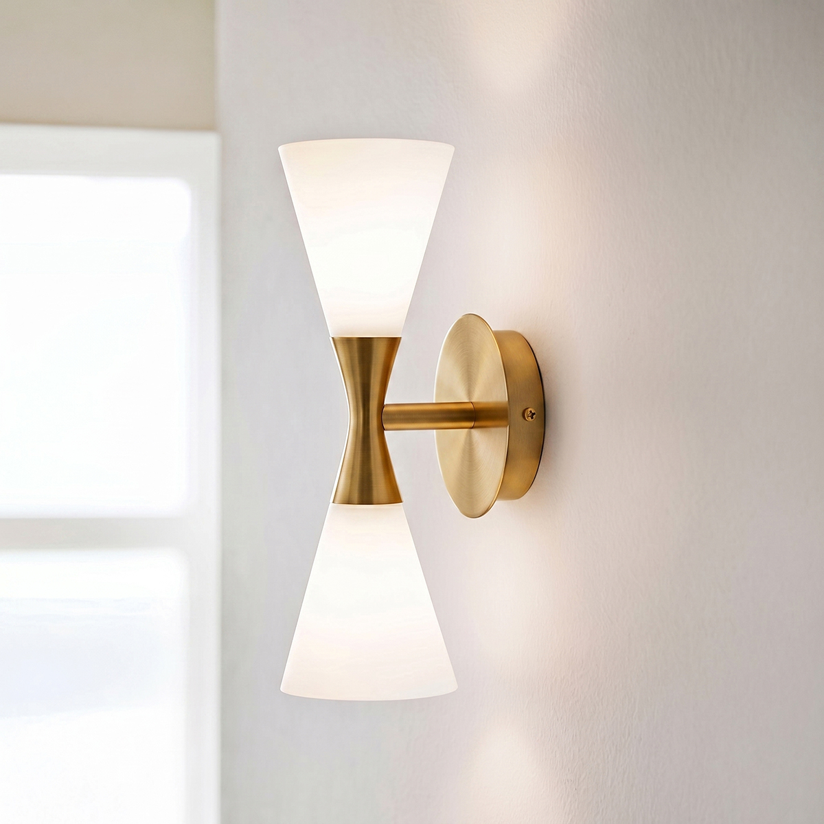Mid-Century Modern Glass Wall Sconce 2 Mid-century modern 2-light hourglass wall sconce in brushed brass finish with frosted glass shades.